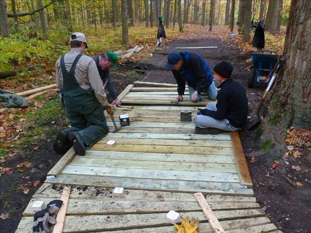 A group of volunteers repairing the boardwalk